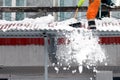 A communal service worker cleans the roof of the house of accumulated snow