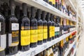 Bottles with excellent grape wine stand on the supermarket shelves. Royalty Free Stock Photo