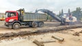 Cutting old asphalt with a special machine and loading it into a dump truck Royalty Free Stock Photo