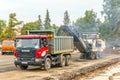 Cutting old asphalt with a special machine and loading it into a dump truck Royalty Free Stock Photo
