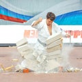 Demonstration performances of athletes karate to break a pile of stones with a blow