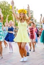 dancing beautiful and elegant stylish girls participating in the carnival costumed women`s bike ride in the summer evening