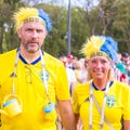 Football fans from Sweden, married couple, with painted faces in national colors before the match England Sweden at the World Cup