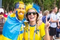 Football fans from Sweden, married couple, with painted faces in national colors before the match England Sweden at the World Cup