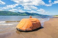 Inflatable liferaft on the Volga River against the backdrop of the Zhiguli Mountains on a summer sunny day