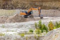 a large kaolin quarry near the city of Kyshtym, Chelyabinsk region. loading the Kamaz truck with an excavator