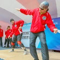 people, men, young people dance a hip-hop sports dance in the Gagarin city park on a summer day. The text in Russian: reads listen