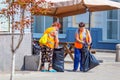 Public service workers clean up the street on a sunny summer day