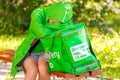 Tired girl food delivery courier fell asleep on a bench