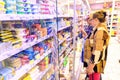 Two mature lovely women choose dairy products in the store in the refrigerator Royalty Free Stock Photo