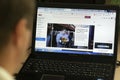 A young man browses the home page of the official website of AOL, a web portal and online service provider, on a laptop at night