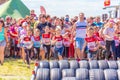 little athletes start in children`s races to overcome obstacles. Text in Russian: race of heroes, children`s start