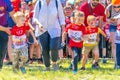 children in a sports uniform are worried before the start in city competitions to overcome obstacles. Text in Russian: race of he