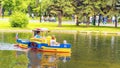 people go boating on a reservoir in Gagarin`s Park on a summer sunny day