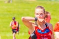 Portrait of dirty beautiful girls participating in the race of heroes to overcome difficult obstacles on a summer sunny day. text