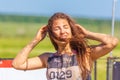 Portrait of dirty beautiful girls participating in the race of heroes to overcome difficult obstacles on a summer sunny day.