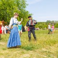 Russian peasant women lead dance to the accordion music for the audience