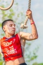 A young athlete, a participant in the race of heroes, overcomes the track on the rings. Text in Russian: race of heroes, champions