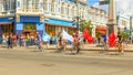 young bicyclists with flags go ahead of the procession, dedicated to graduates of schools on Leningradskaya Street on a sunny summ