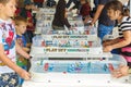 Young people play table hockey in Gagarin Park on a sunny summer day