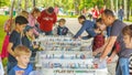 Young people play table hockey in Gagarin Park on a sunny summer day