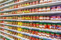 A large selection of beautiful canned and pickled tomatoes in a supermarket.