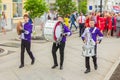 A group of drummers at a festive parade of high school graduates