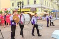 A group of drummers at a festive parade of high school graduates.