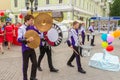 A group of drummers at a festive parade of high school graduates.