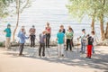 a group of older people studying Scandinavian walking on the Volga River Embankment on a summer sunny day Royalty Free Stock Photo