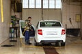 A male driver washes his car in a self-service car service