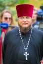 portrait of a clergyman with a cross on a city holiday