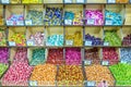 a large selection of sweets lies on a shelf in a store.