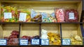 a large selection of sweets lies on a shelf in a store.