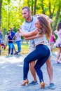 A beautiful sexy couple dancing in a city park