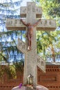 Statue of the crucified Christ on the cross near the wall of the Cathedral of the Life-Giving Trinity. Orenburg region Royalty Free Stock Photo