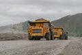 A BelAZ dump truck driving through an open pit mine.