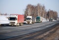 Auto trucks length gages go on Minskoye Highway in the winter clear morning. Royalty Free Stock Photo