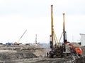 Russia, Sochi 16.04.2021. An area with excavated earth cranes with construction materials and workers. Construction