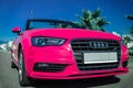 Russia Sochi August 2019 pink Audi convertible near palm trees in the Parking lot. summer travel