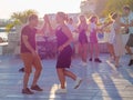 Russia, Sochi 07.06.2020. Couples dance salsa on a wooden platform on a street in in contour