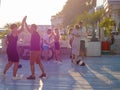 Russia, Sochi 07.06.2020. Couples dancing salsa on a wooden platform on the street on a summer day in contour