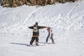 Ski resort, instructor is teaching a young girl to ski, Opening of the ski season