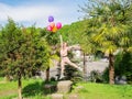 Russia, Sochi 3.05.2022. The girl flies on colorful balloons on the street Royalty Free Stock Photo