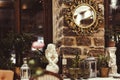 Russia, Sochi 02.10.2021. A gold framed round mirror hangs on a stone wall by the windowsill with angels, lanterns and