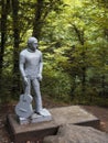 Russia, Sochi 12.07.2020. A gray monument to Vladimir Vysotsky with a guitar stands in a national park surrounded by Royalty Free Stock Photo