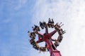 Russia, Sochi 14.05.2022. A large round attraction turned the merry people upside down, raising them high to the sky