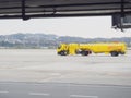 Russia, Sochi 02.11.2021. A large yellow truck with a flammable sign is driving across the runway. Airfield tanker