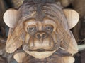 Russia, Sochi 06.06.2021. The muzzle of a wooden figurine of a monkey covering the ears with his hands. Can not hear