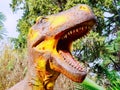 Russia, Sochi 18.02.2020. A yellow-brown dinosaur head with an open mouth. Closeup photo